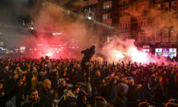 What sparked violent clashes between football fans in Amsterdam?